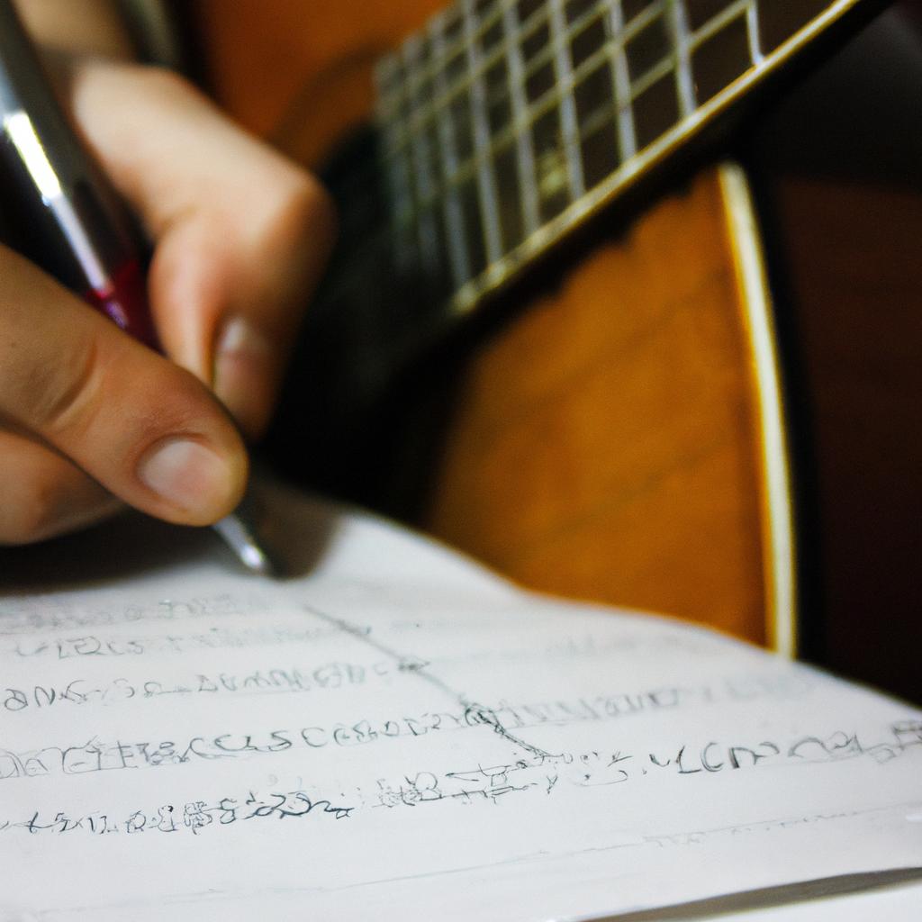 Person playing guitar, writing music
