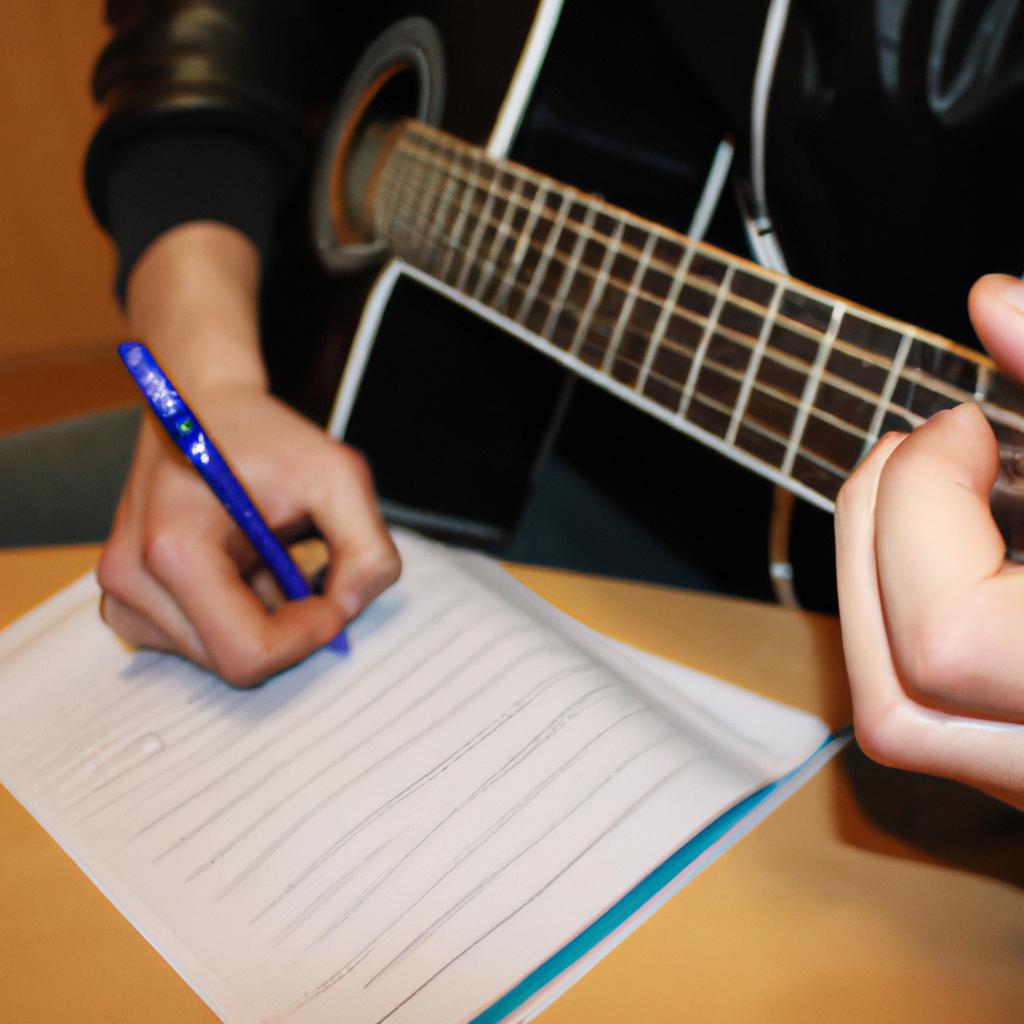 Man playing guitar, writing lyrics